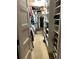 Well-organized walk-in closet with built-in shelving and hanging rods for ample storage at 512 173Rd E Ave, North Redington Beach, FL 33708
