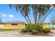 Charming home featuring palm trees and lush landscaping, enhancing its curb appeal at 512 173Rd E Ave, North Redington Beach, FL 33708