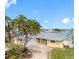 Beautiful home with lush palm trees and a spacious driveway providing ample parking at 512 173Rd E Ave, North Redington Beach, FL 33708
