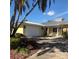 Charming home with a two-car garage, well-manicured landscaping, and inviting front porch at 512 173Rd E Ave, North Redington Beach, FL 33708