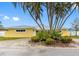 Charming yellow home with lush tropical landscaping and a circular driveway at 512 173Rd E Ave, North Redington Beach, FL 33708