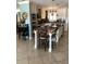 Well-equipped kitchen with white cabinets, stainless steel appliances, and a center island with bar seating at 512 173Rd E Ave, North Redington Beach, FL 33708