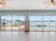 Living room area with sliding glass doors overlooking pool and canal at 512 173Rd E Ave, North Redington Beach, FL 33708