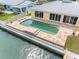 Private backyard pool with adjacent home featuring a wall of glass doors for indoor-outdoor living at 512 173Rd E Ave, North Redington Beach, FL 33708