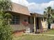 Quaint single-story home with an American flag, front porch, and a well-lit exterior at 5217 18Th S Ave, Gulfport, FL 33707