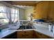 Kitchen featuring laminate countertops, double basin sink, and bright window at 5217 18Th S Ave, Gulfport, FL 33707