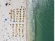 Aerial view of crowded beach featuring rows of colorful umbrellas and ocean views at 525 Mandalay Ave # 33, Clearwater Beach, FL 33767