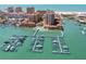 Beautiful aerial view of waterfront condominiums, a marina filled with boats, and the serene ocean at 525 Mandalay Ave # 33, Clearwater Beach, FL 33767