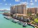 Stunning aerial view of waterfront townhomes with boat docks and high-rise condominiums at 525 Mandalay Ave # 33, Clearwater Beach, FL 33767