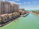 Impressive aerial view showcasing waterfront condominiums, townhouses, and a canal filled with boats, near the ocean at 525 Mandalay Ave # 33, Clearwater Beach, FL 33767