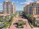 Stunning aerial view of luxury condo community with lush landscaping, a secure entrance and high-rise buildings at 525 Mandalay Ave # 33, Clearwater Beach, FL 33767