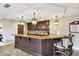 Entertain at home with this stunning bar area with custom cabinets and stone countertops at 525 Mandalay Ave # 33, Clearwater Beach, FL 33767