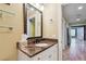 Bathroom featuring a marble countertop sink, a framed mirror, and neutral wall paint at 525 Mandalay Ave # 33, Clearwater Beach, FL 33767