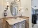 Bathroom featuring an ornate mirror, sconces, vanity, and decorative tilework at 525 Mandalay Ave # 33, Clearwater Beach, FL 33767
