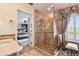 Bathroom with a glass shower, vanity, and views into the main bedroom at 525 Mandalay Ave # 33, Clearwater Beach, FL 33767