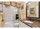 Bathroom showcasing a shower-over-tub setup, a framed mirror, and granite countertops at 525 Mandalay Ave # 33, Clearwater Beach, FL 33767