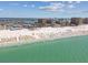 Scenic aerial view of a popular beach, capturing the sparkling ocean, sandy shore, and vibrant beach umbrellas at 525 Mandalay Ave # 33, Clearwater Beach, FL 33767