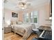 Cozy bedroom with a ceiling fan, a window with shutters, and a compact workspace at 525 Mandalay Ave # 33, Clearwater Beach, FL 33767
