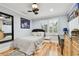 Well-lit bedroom with hardwood floors, a comfortable bed, and a stylish desk area at 525 Mandalay Ave # 33, Clearwater Beach, FL 33767
