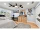 Bright bedroom featuring hardwood floors, a ceiling fan, and natural light from the windows at 525 Mandalay Ave # 33, Clearwater Beach, FL 33767