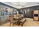 Elegant dining area featuring built-in cabinetry, stylish chandelier, dark accent wall and rustic wood table at 525 Mandalay Ave # 33, Clearwater Beach, FL 33767