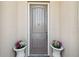 Inviting front door with decorative planters on each side, creating a warm welcome to the home at 525 Mandalay Ave # 33, Clearwater Beach, FL 33767
