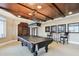 Luxurious game room features a pool table, custom wood ceiling, and decorative lighting fixtures at 525 Mandalay Ave # 33, Clearwater Beach, FL 33767
