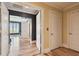 Bright hallway featuring hardwood floors leading to a bedroom with shuttered windows at 525 Mandalay Ave # 33, Clearwater Beach, FL 33767