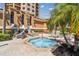 Relaxing hot tub area with lounge chairs, set in a beautifully landscaped outdoor space by the building at 525 Mandalay Ave # 33, Clearwater Beach, FL 33767