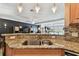 Kitchen area featuring stainless steel sink, granite counters, and breakfast bar open to the spacious living areas at 525 Mandalay Ave # 33, Clearwater Beach, FL 33767