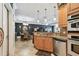 Kitchen with granite countertops, stainless steel appliances, an open-concept design, and views of the living room at 525 Mandalay Ave # 33, Clearwater Beach, FL 33767