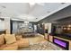 Spacious living room with tile flooring, dark accent wall, electric fireplace, and modern shelving unit at 525 Mandalay Ave # 33, Clearwater Beach, FL 33767