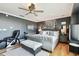 Spacious main bedroom featuring a king-size bed, ceiling fan, and a comfortable reading area at 525 Mandalay Ave # 33, Clearwater Beach, FL 33767