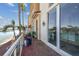 Brick patio with waterfront view, sliding glass doors, and potted plants at 525 Mandalay Ave # 33, Clearwater Beach, FL 33767