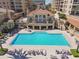 Stunning aerial shot of a luxurious pool with lounge chairs and a clubhouse; an inviting place to relax and unwind at 525 Mandalay Ave # 33, Clearwater Beach, FL 33767
