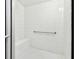 Clean, tiled shower stall with a built-in seat and grab bar for added convenience and safety at 525 Mandalay Ave # 33, Clearwater Beach, FL 33767
