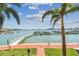 Scenic waterfront view of boat docks and city skyline framed by palm trees at 525 Mandalay Ave # 33, Clearwater Beach, FL 33767