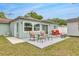 Backyard patio space with outdoor seating, an extended patio, and green grass at 5317 Black Pine Dr, Tampa, FL 33624