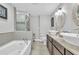 Modern bathroom featuring a soaking tub, glass shower, and dual sinks at 5317 Black Pine Dr, Tampa, FL 33624
