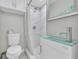 Modern bathroom with glass sink, tiled shower with rainfall shower head, and white marble accents at 5317 Black Pine Dr, Tampa, FL 33624