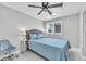 Comfortable bedroom featuring a ceiling fan, window for natural light, and a calming blue palette at 5317 Black Pine Dr, Tampa, FL 33624