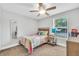 Cozy bedroom with a colorful quilt, a side table, window, and a ceiling fan at 5317 Black Pine Dr, Tampa, FL 33624