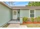 Inviting front entrance featuring a white door, stone accents, and fresh landscaping at 5317 Black Pine Dr, Tampa, FL 33624
