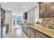 Modern kitchen with stainless steel appliances, granite countertops and a mosaic backsplash at 5317 Black Pine Dr, Tampa, FL 33624