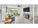 Bright living room with a large window offering a view of the landscaped backyard at 5317 Black Pine Dr, Tampa, FL 33624