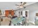 Open concept room with dining table, kitchen bar, and living area with orange accent wall at 5317 Black Pine Dr, Tampa, FL 33624