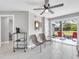 Inviting living room featuring a large window, tile floors, ceiling fan and sliding doors at 5317 Black Pine Dr, Tampa, FL 33624