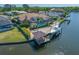 Waterfront home featuring a screened-in pool, boat dock, and well-maintained landscaping at 5812 Mariners Watch Dr, Tampa, FL 33615