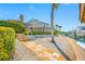 Landscaped backyard with stone walkway leading to the screen enclosed pool at 5812 Mariners Watch Dr, Tampa, FL 33615