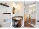 Powder room featuring granite countertop and decorative shelves with nearby bedroom at 5812 Mariners Watch Dr, Tampa, FL 33615